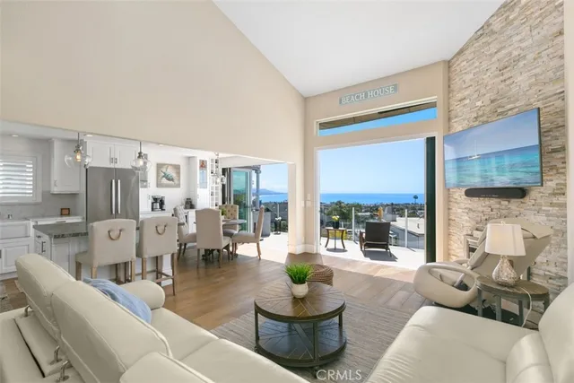a view of a balcony with chairs and a potted plant