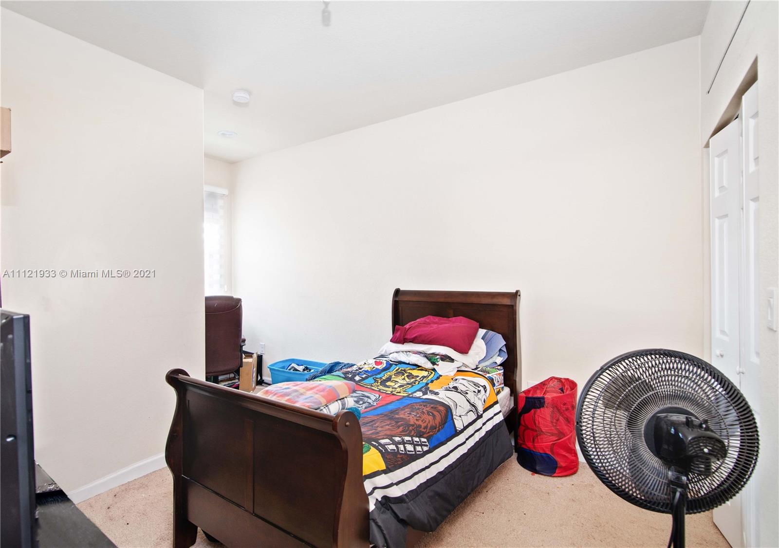 3213 Southeast 5th Court Homestead, FL 33033 - Photo 13 of 19 a bedroom with a bed and a table in it