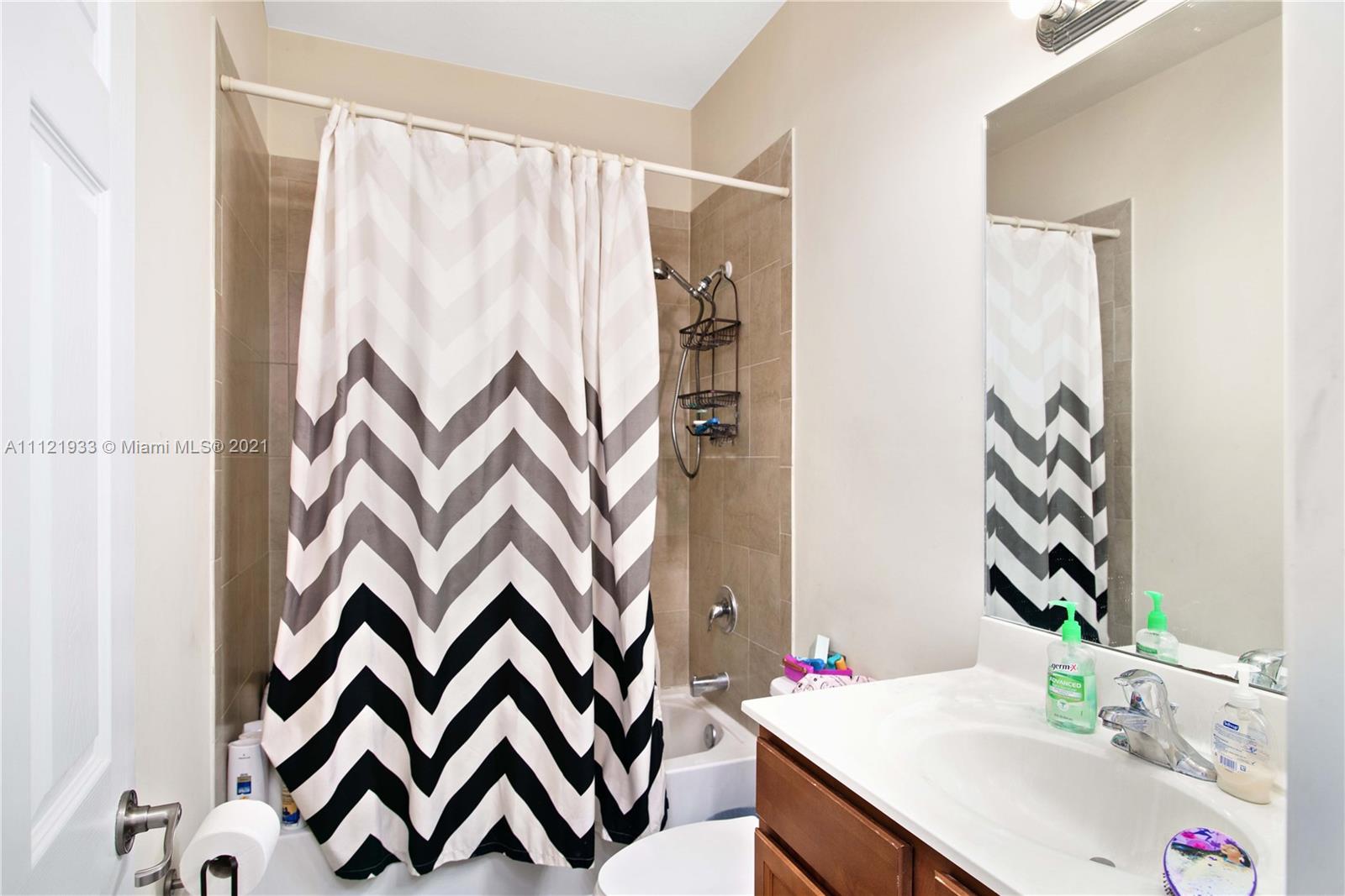 3213 Southeast 5th Court Homestead, FL 33033 - Photo 14 of 19 a bathroom with a sink and a mirror