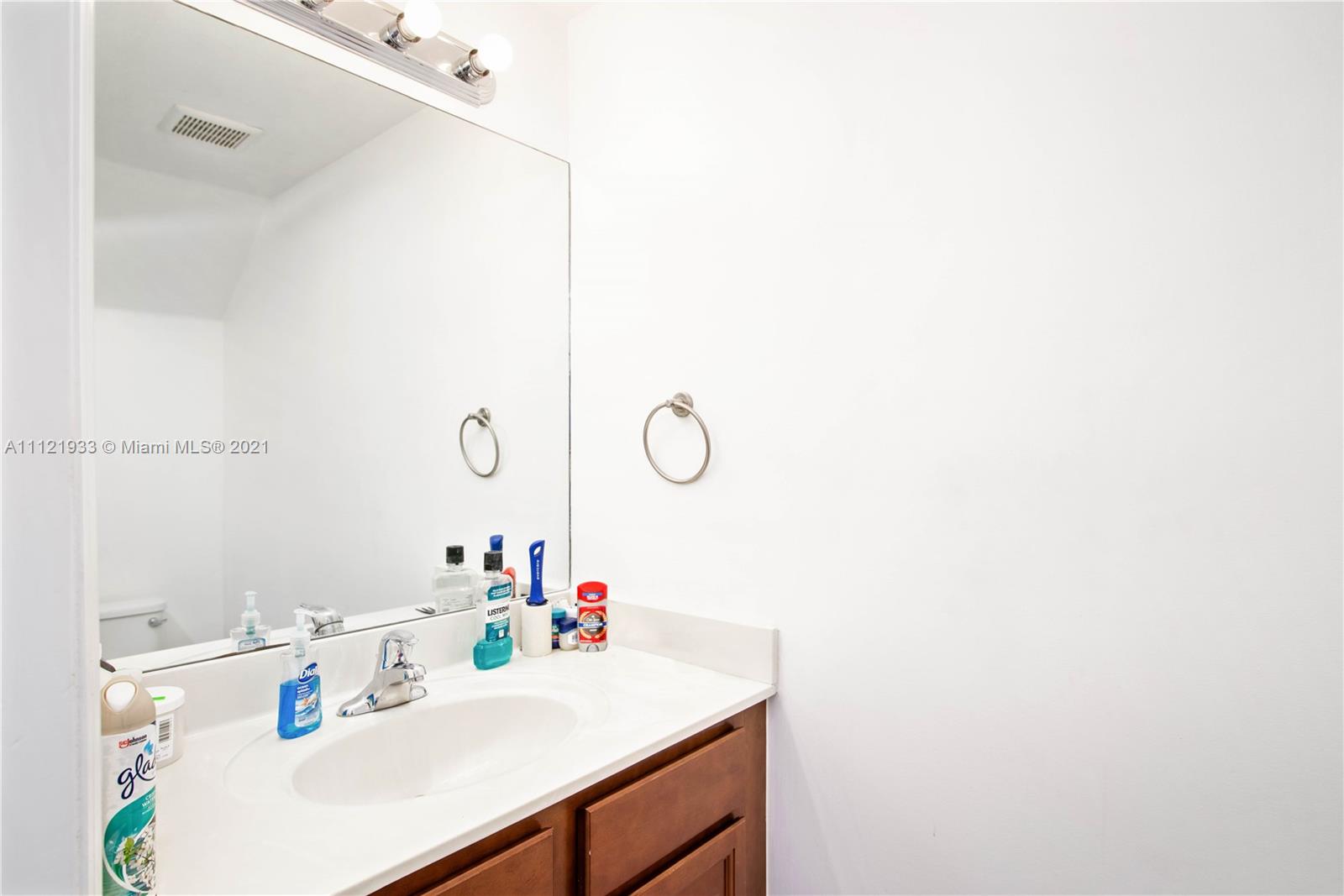 3213 Southeast 5th Court Homestead, FL 33033 - Photo 8 of 19 a bathroom with a sink vanity and a mirror