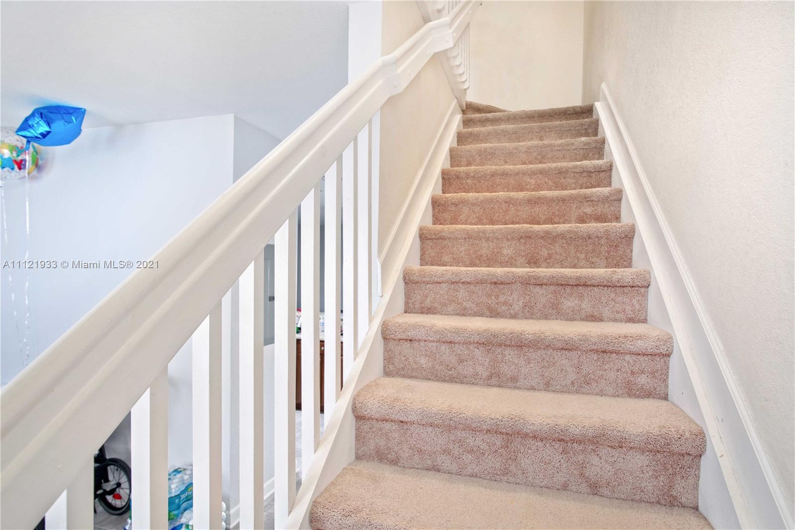 3213 Southeast 5th Court Homestead, FL 33033 - Photo 9 of 19 a view of staircase with white walls and a potted plant
