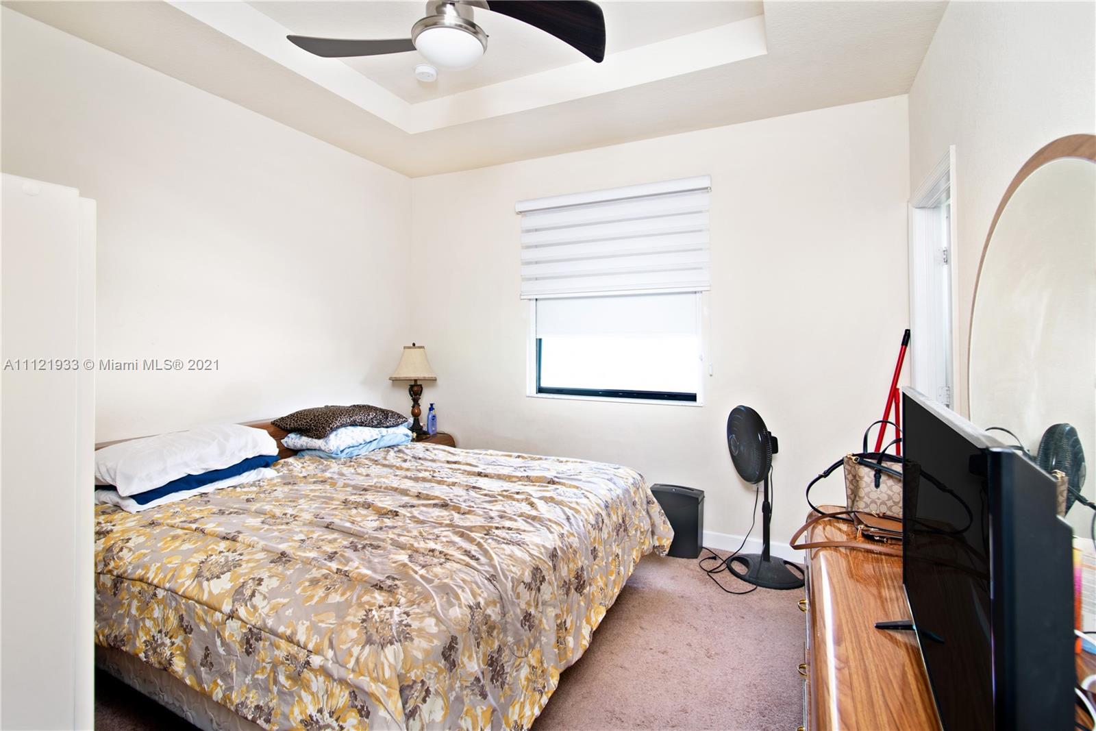 3213 Southeast 5th Court Homestead, FL 33033 - Photo 10 of 19 a bedroom with a bed and a window