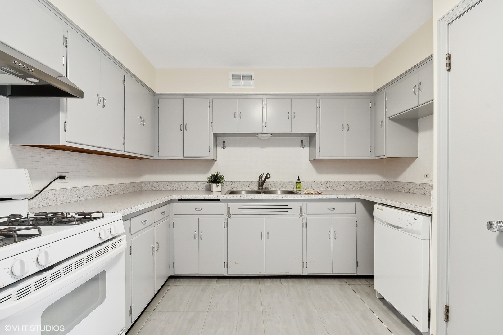 402 Berry Road Barrington, IL 60010 - Photo 6 of 22 a kitchen with granite countertop white cabinets and white appliances