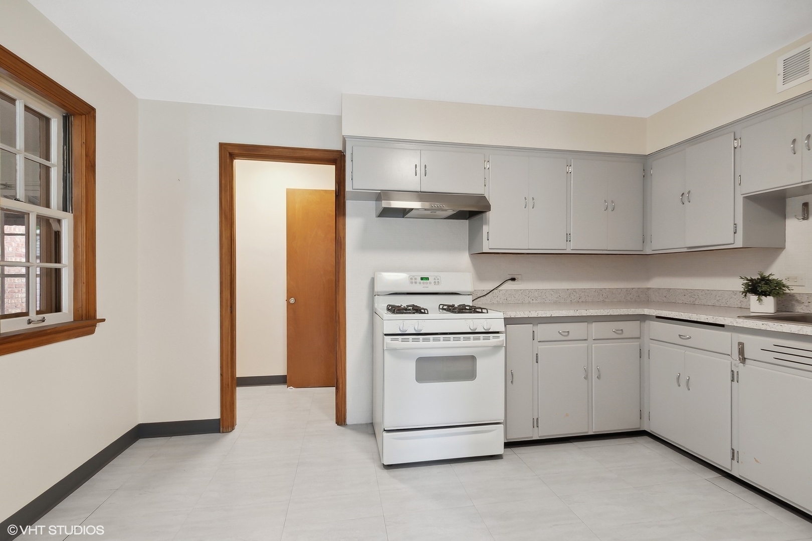 402 Berry Road Barrington, IL 60010 - Photo 7 of 22 a kitchen with cabinets appliances and a window