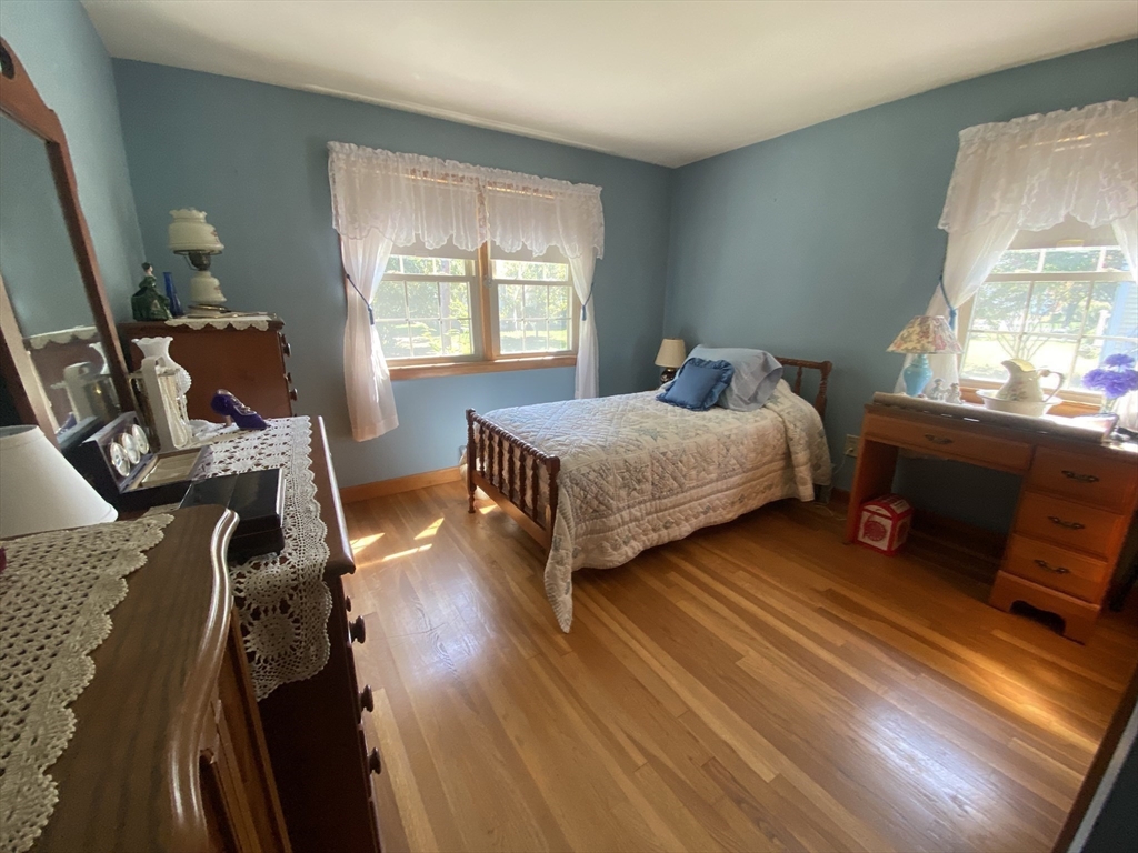 11 Highland Avenue Clinton, MA 01510 - Photo 14 of 25 a bedroom with a bed and wooden floor