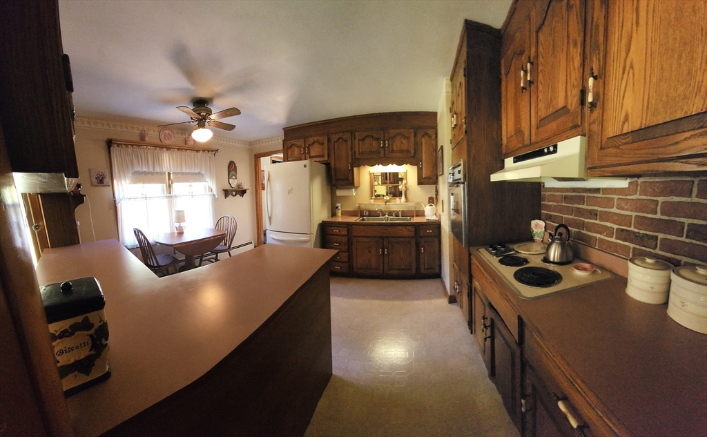 11 Highland Avenue Clinton, MA 01510 - Photo 8 of 25 a kitchen with sink refrigerator and stove