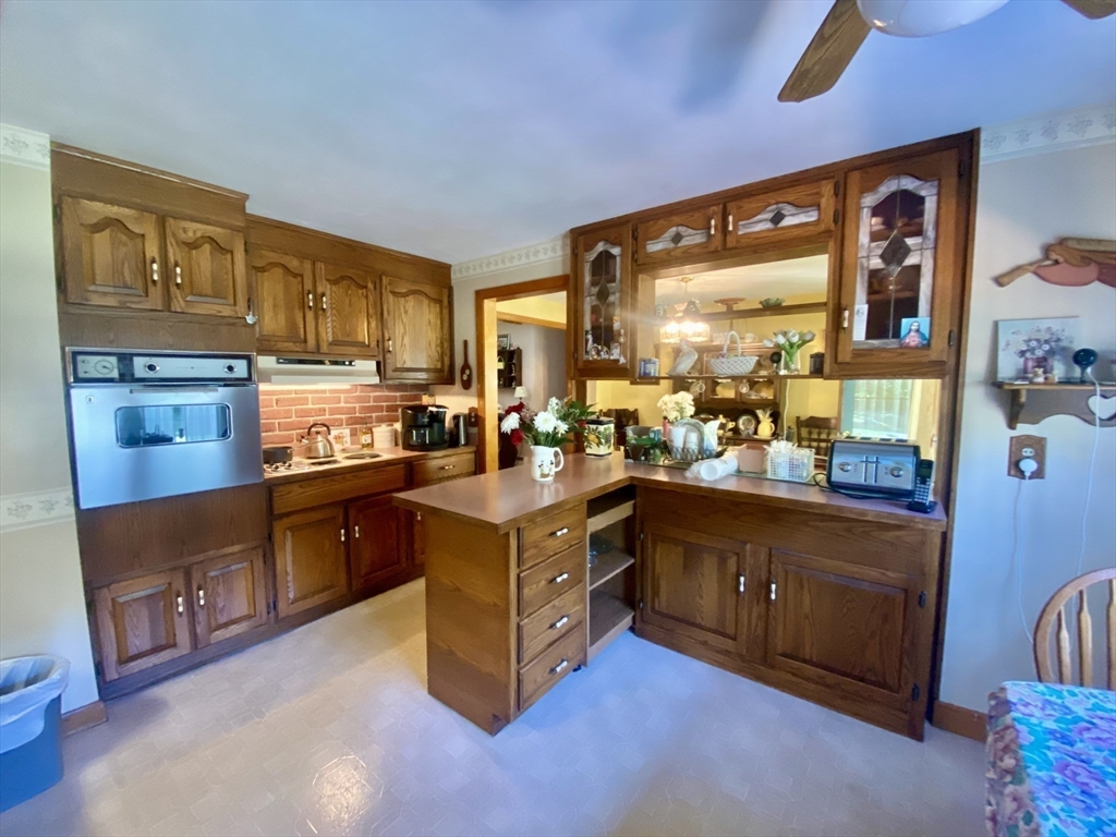 11 Highland Avenue Clinton, MA 01510 - Photo 9 of 25 a kitchen with stainless steel appliances granite countertop a stove and a refrigerator
