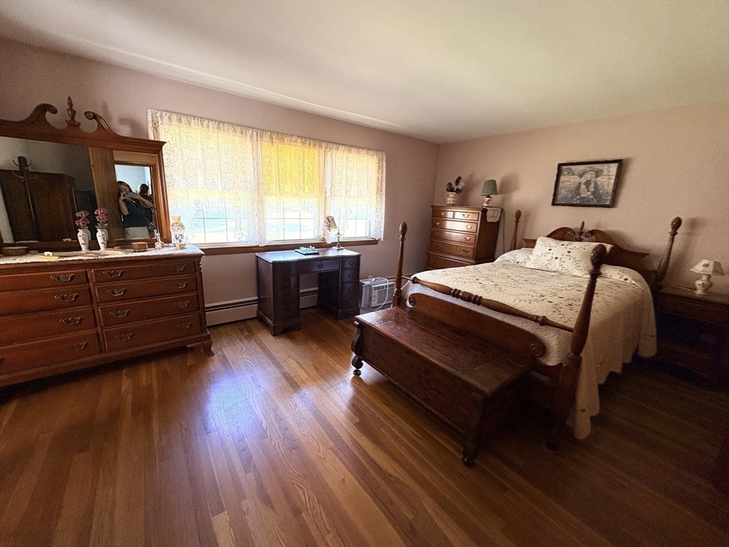 11 Highland Avenue Clinton, MA 01510 - Photo 10 of 25 a bedroom with a bed and wooden floor