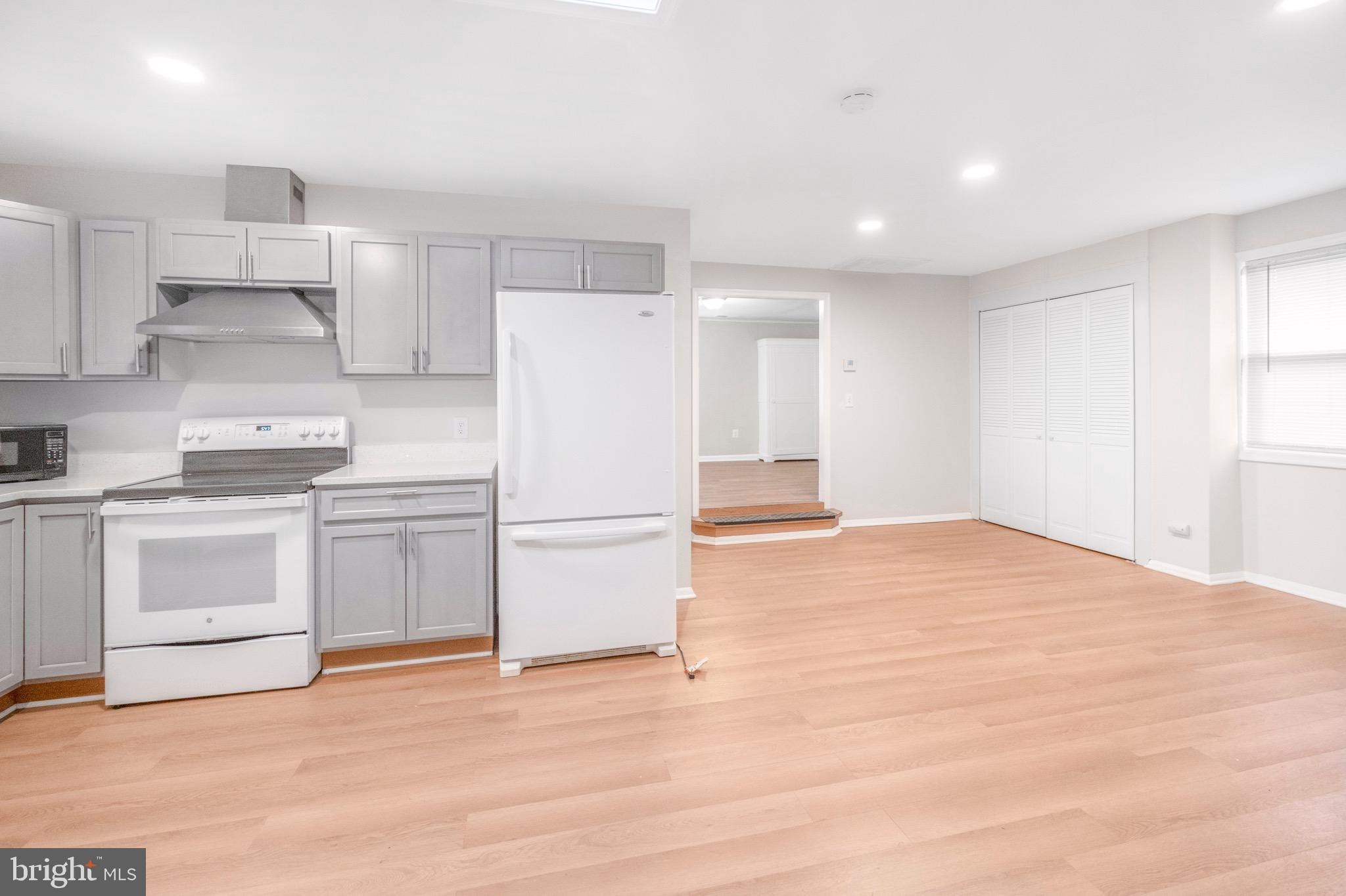 3304 Enterprise Road, Unit B Bowie, MD 20721 - Photo 4 of 8 a kitchen with white cabinets and white appliances