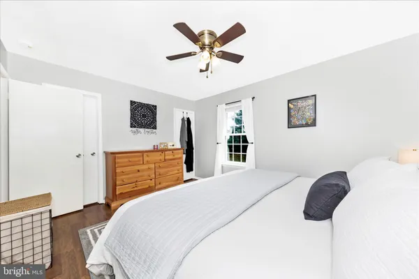 a bedroom with a bed and a ceiling fan