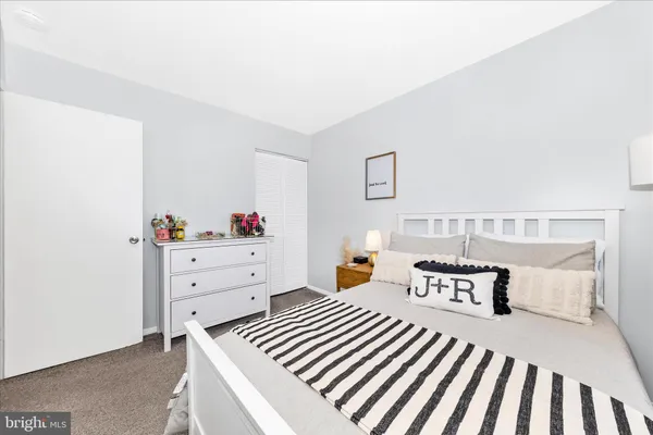 a bed room with a bed and a night stand