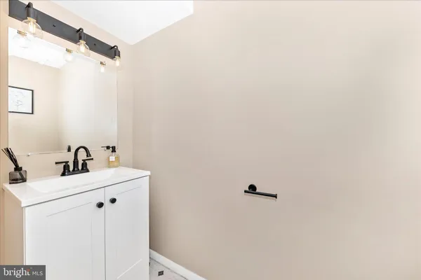 a bathroom with a sink a toilet and mirror