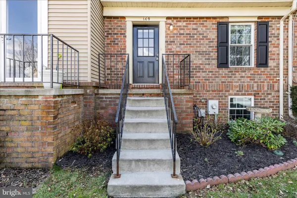 a view of a brick house with many windows