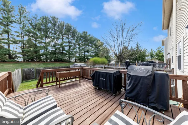 a view of a roof deck with wooden floor and fence