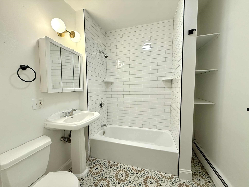 19 Howell Street, Unit 2 Boston, MA 02125 - Photo 14 of 16 a bathroom with a sink toilet and shower