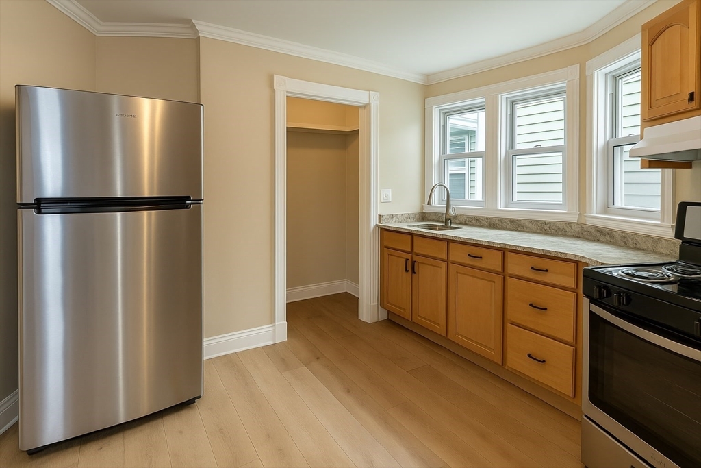 19 Howell Street, Unit 2 Boston, MA 02125 - Photo 2 of 16 a kitchen with stainless steel appliances a refrigerator sink and cabinets