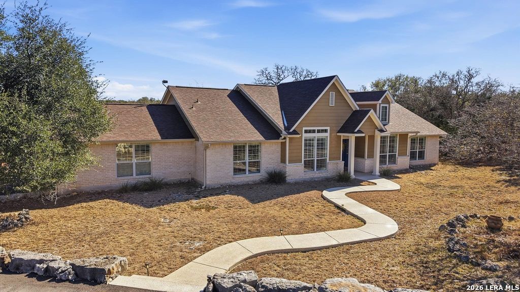 318 River Ridge Boerne, TX 78006 - Photo 3 of 46 a front view of a house with a yard outdoor seating and covered with trees