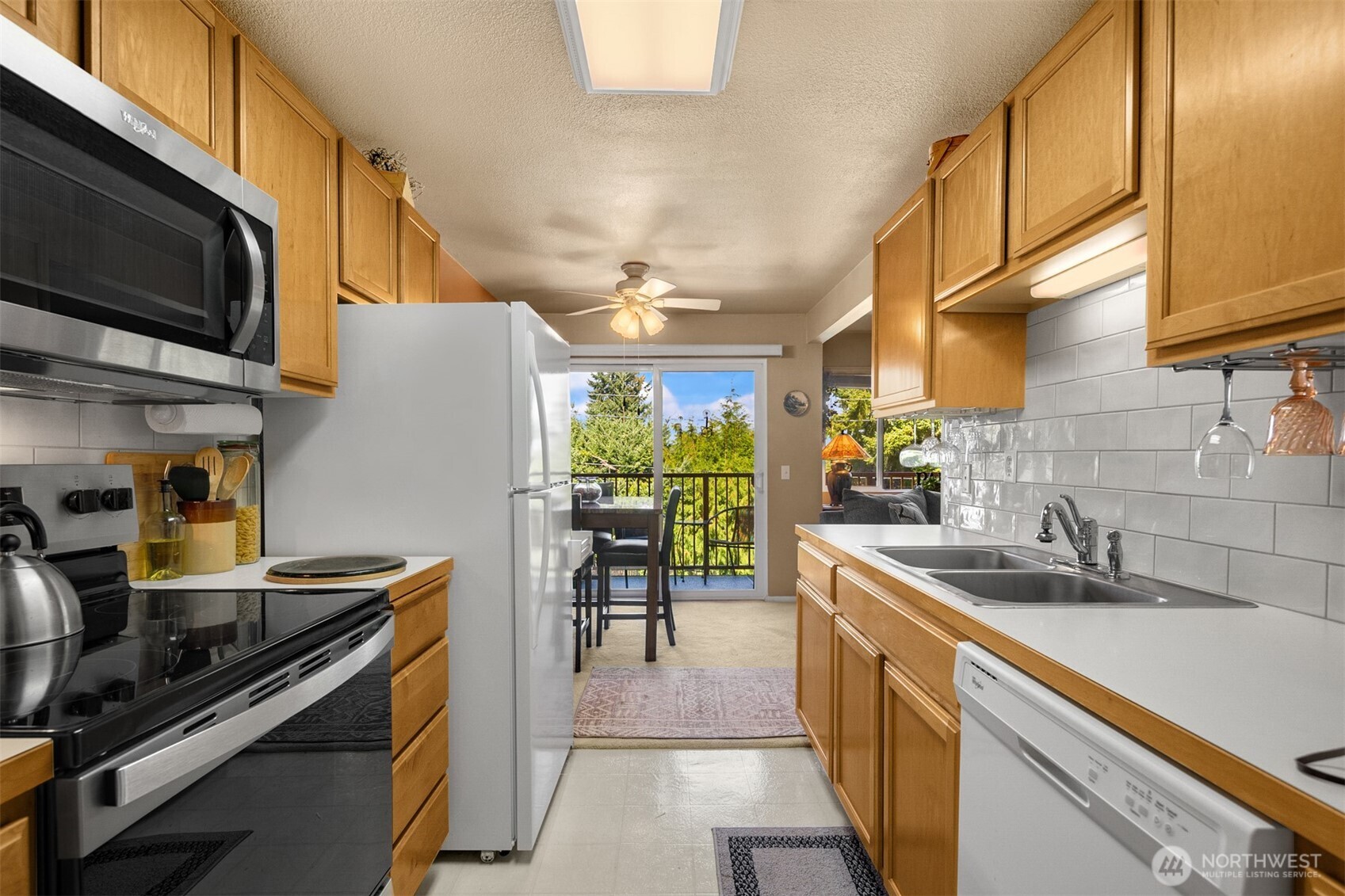 330 Elm Street, Unit 305 Everett, WA 98203 - Photo 6 of 25 a kitchen with stainless steel appliances a stove a sink and a microwave