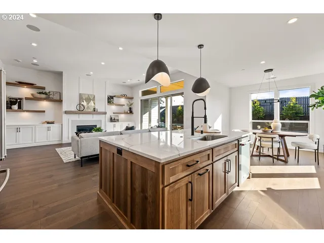 a kitchen with stainless steel appliances granite countertop a stove and a large cabinets