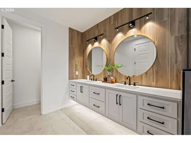 a bathroom with a double vanity sink and a mirror