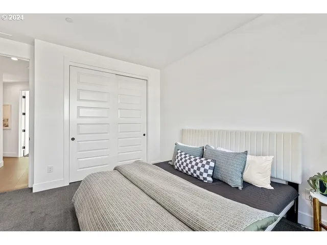 a bedroom with a bed and a chair