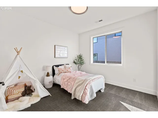 a bedroom with a bed and a window