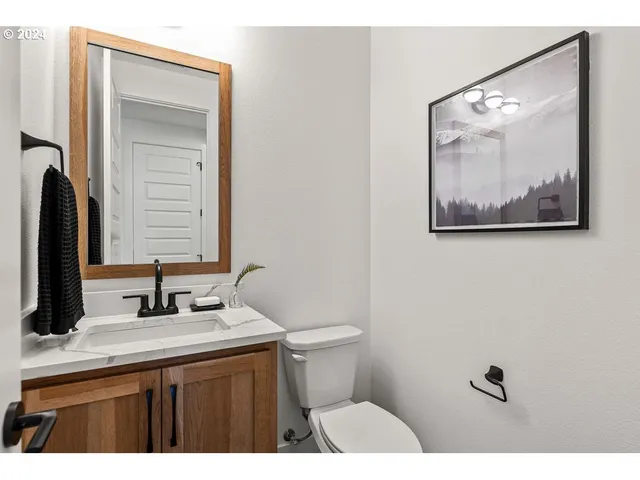 a bathroom with a sink vanity and toilet