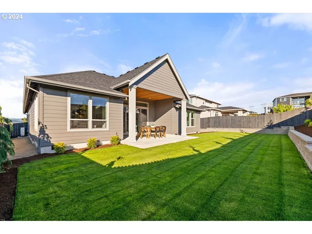 a view of a house with a yard and sitting area
