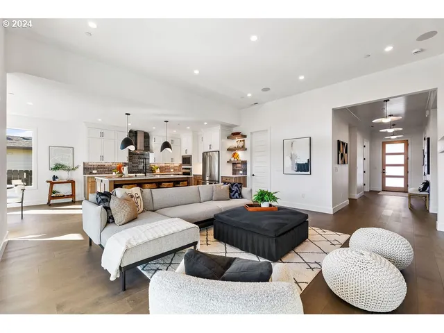 a living room with furniture and kitchen view