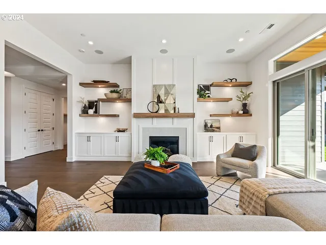 a living room with furniture fireplace and window