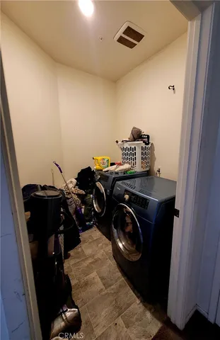 a view of storage and utility room with washer and dryer