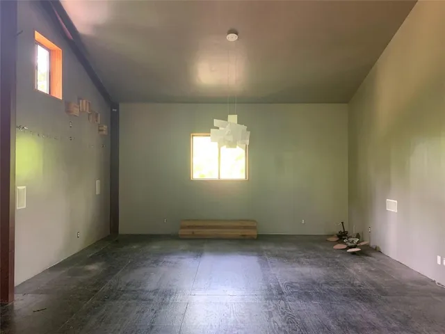 an empty room with a empty space and windows