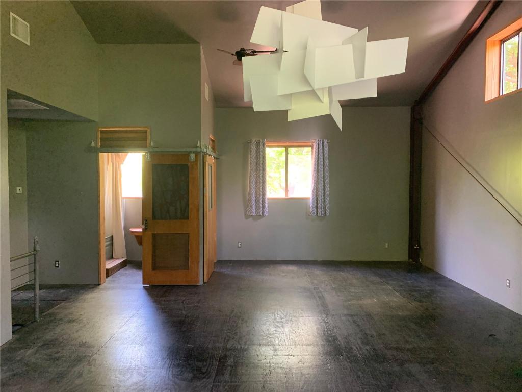 640 Tillery Street Austin, TX 78702 - Photo 14 of 22 an empty room with wooden floor and windows