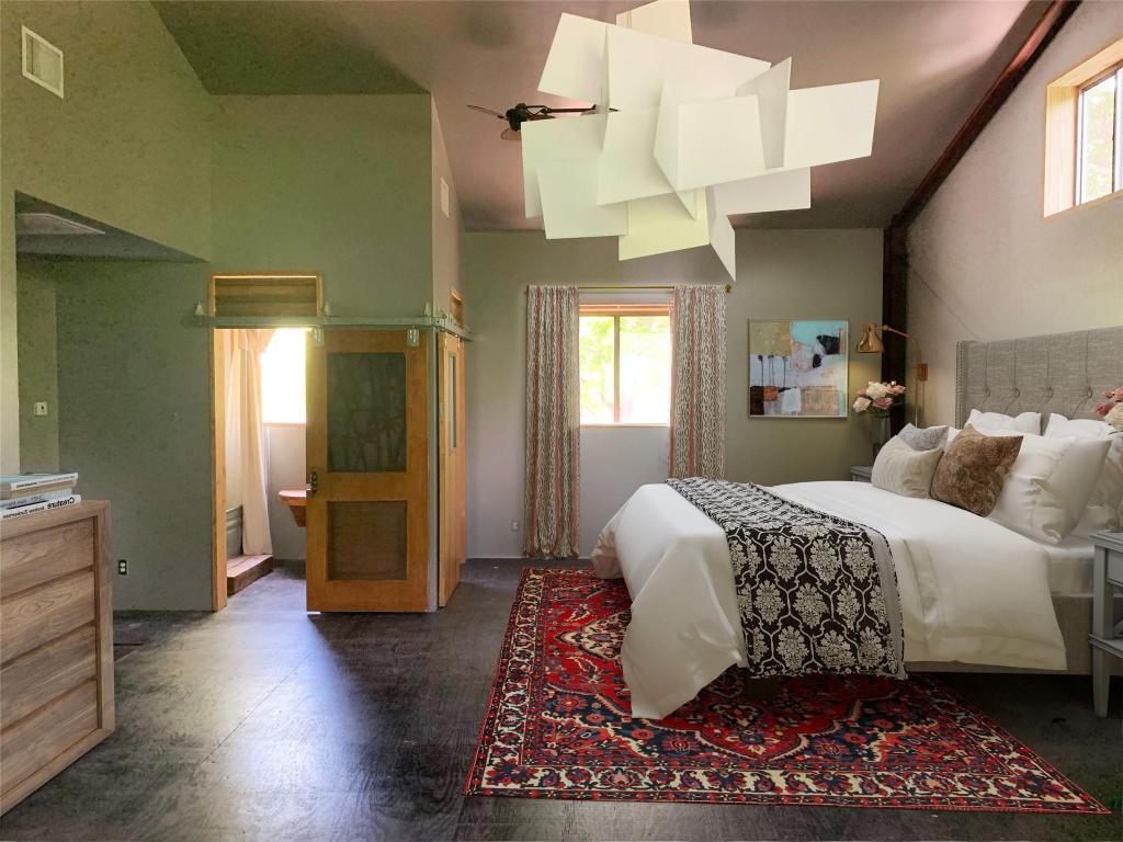 640 Tillery Street Austin, TX 78702 - Photo 15 of 22 a bedroom with a large bed and a chandelier