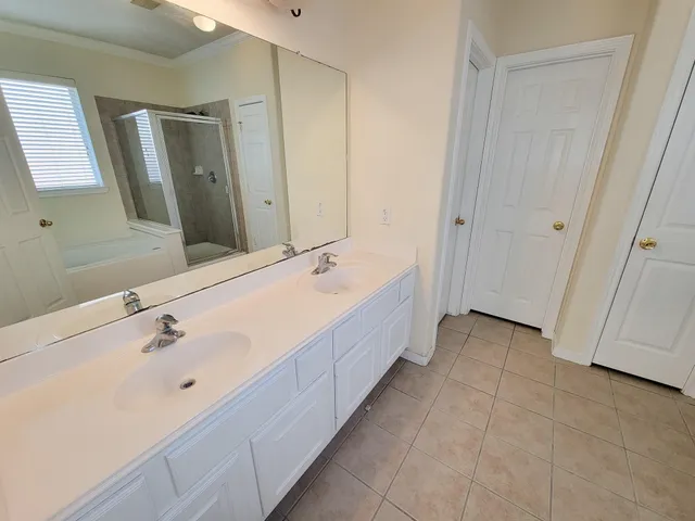 a spacious bathroom with a double vanity sink and a mirror