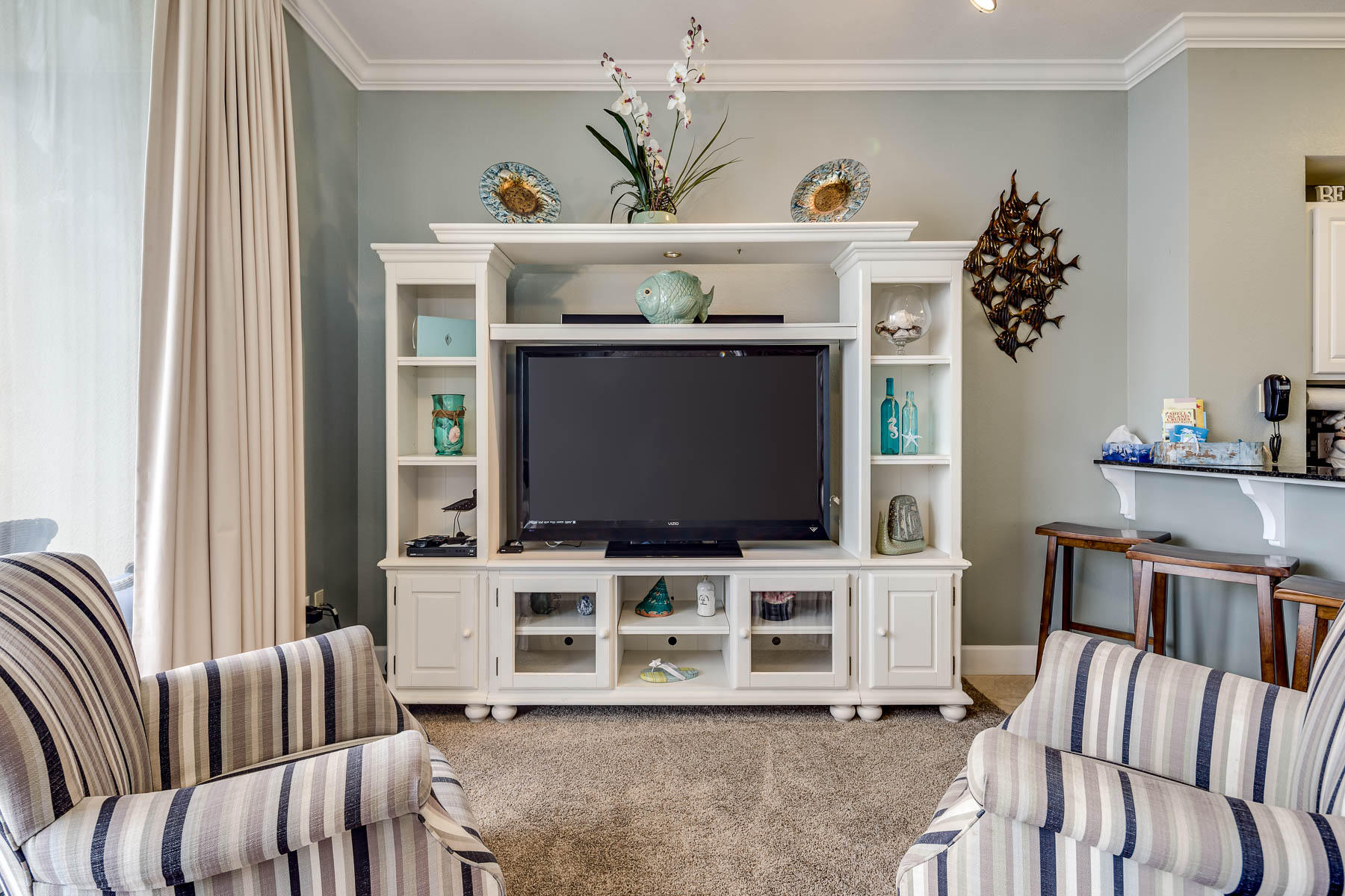 16819 Front Beach Road, Unit 3011 Panama City Beach, FL 32413 - Photo 2 of 28 a living room with furniture and a flat screen tv