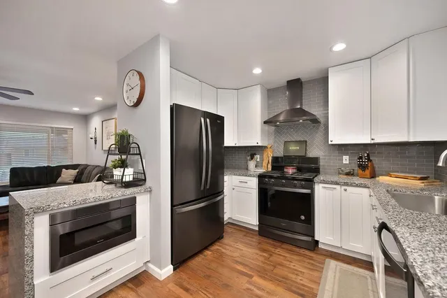 a kitchen with a refrigerator stove and sink