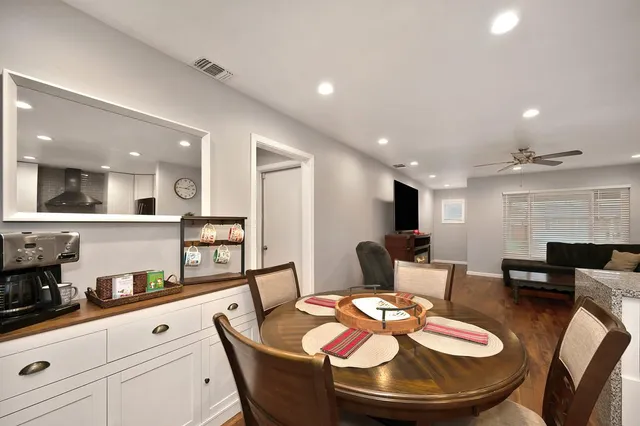 a dining room with furniture and wooden floor