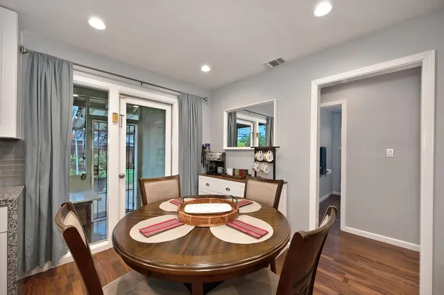 a view of a dining room with furniture a chandelier and wooden floor