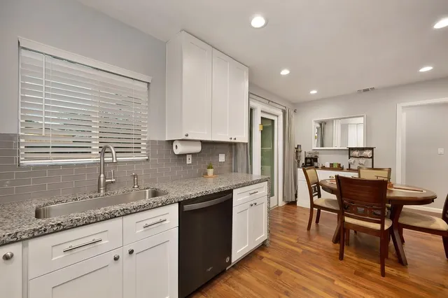a kitchen with granite countertop sink cabinets and stainless steel appliances
