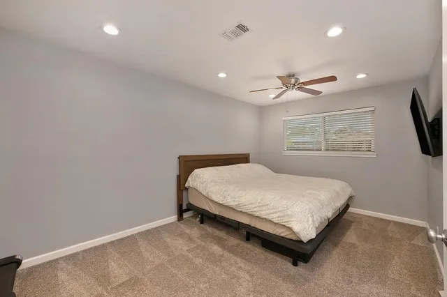 a bed sitting in a room next to a window