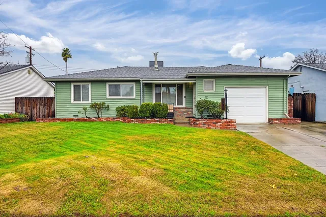 a front view of a house with garden