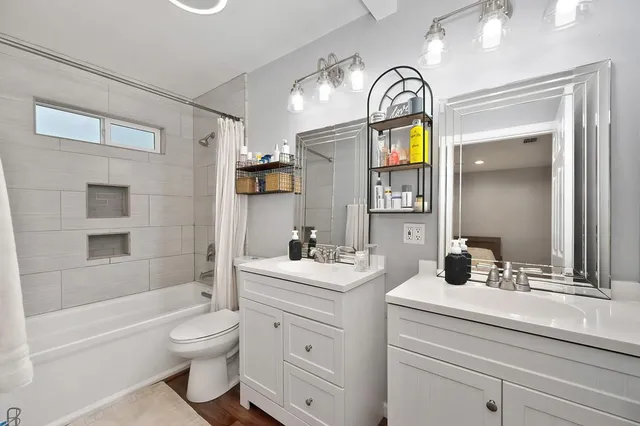 a bathroom with a sink a toilet and a mirror