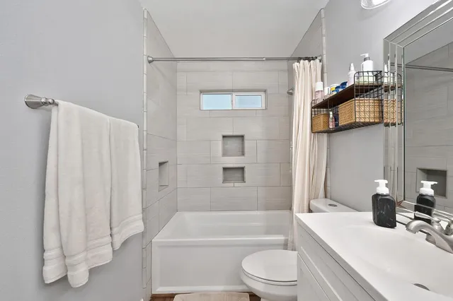 a bathroom with a sink toilet and shower