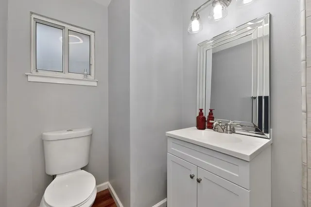 a bathroom with a toilet sink and mirror