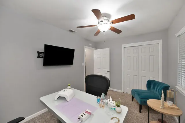 a work room with furniture and a flat screen tv
