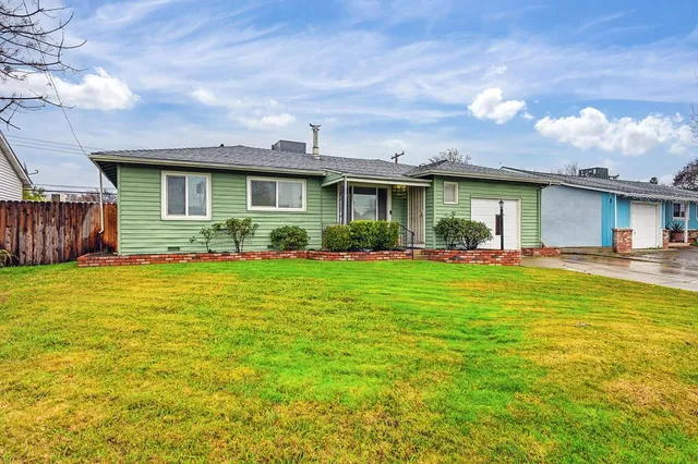 a front view of house with yard and outdoor seating