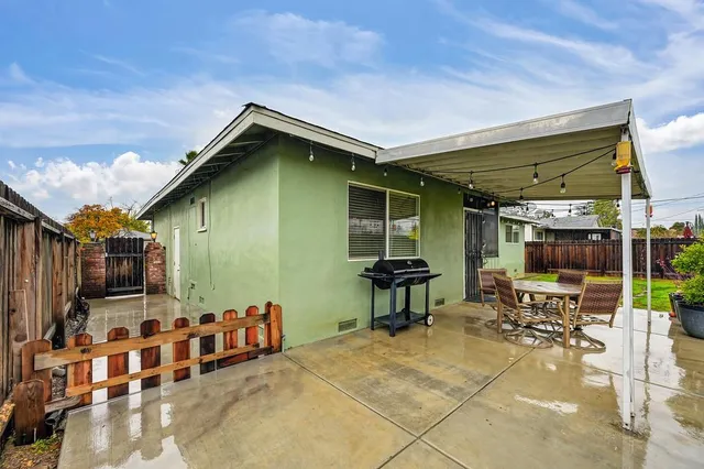 a patio with table and chairs