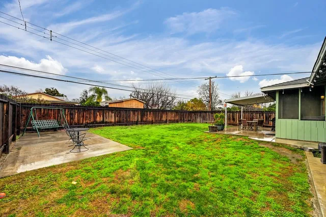 a view of a swimming pool with a yard