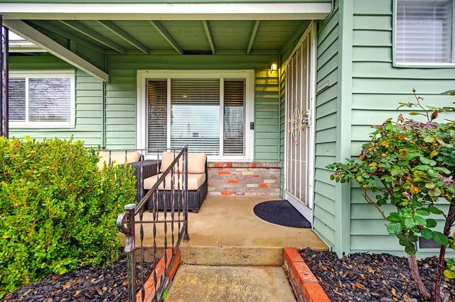 a view of a patio with table and chairs and potted plants